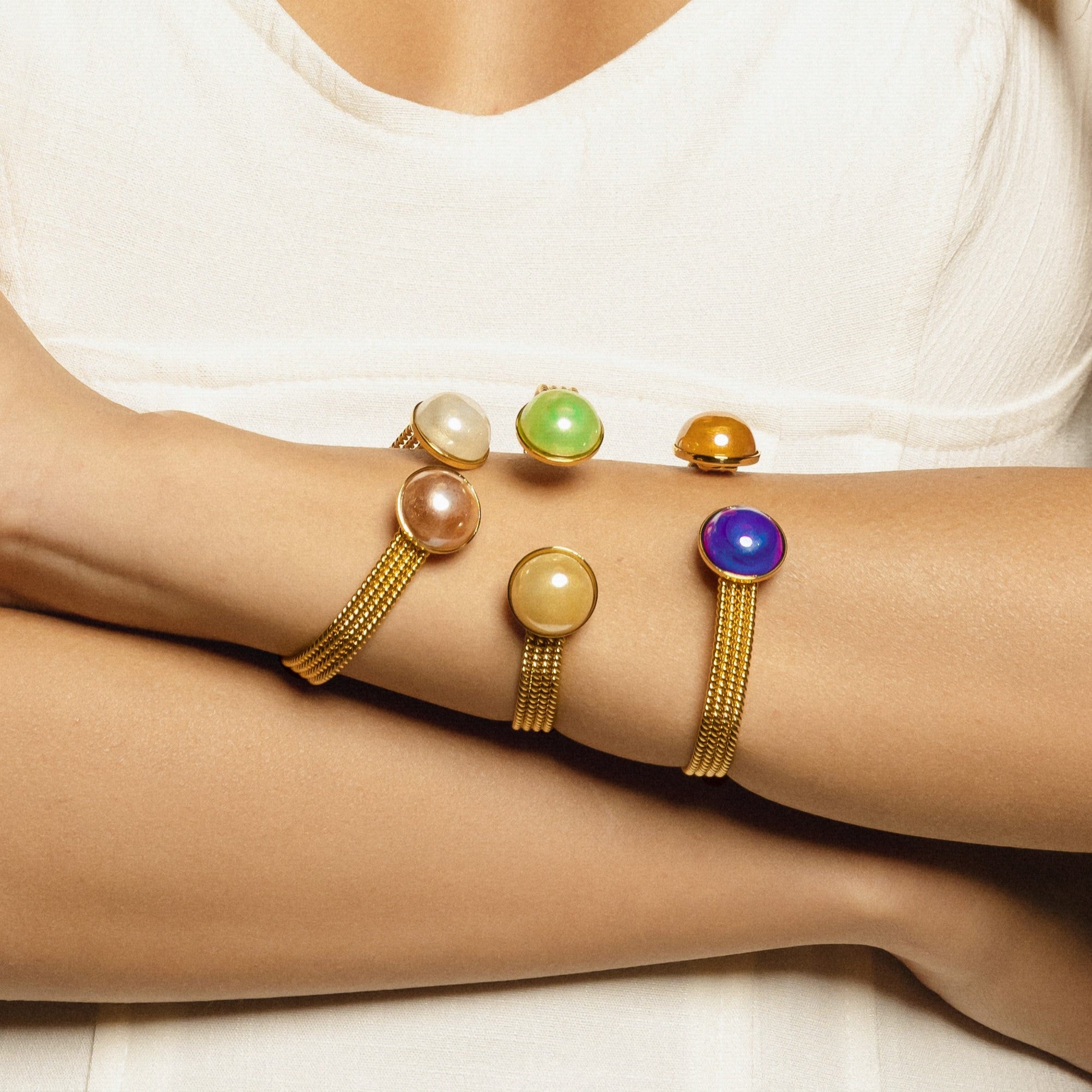 Model wearing MURRINAMURANO Venezia Bracelets from the Drop Collection, handcrafted in Original Murano glass, 18KT Gold Finish over Brass. Made in Italy – murrinamurano.us