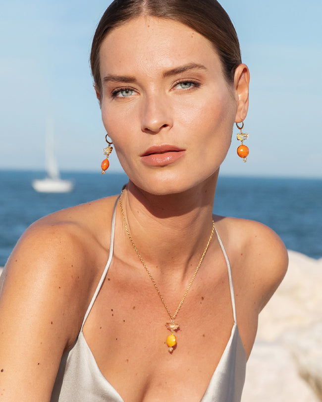Model wearing MURRINAMURANO Venezia earrings and necklace , Murano glass with 18KT Gold Finish over Brass and Stainless Steel clasp, Made in Italy – Ocean Odyssey Collection