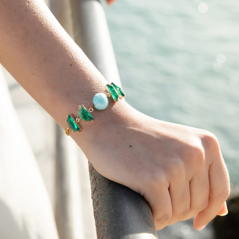 Model wearing MURRINAMURANO Venezia bracelet from the Ocean Odyssey Collection, handcrafted in Original Murano glass, 18KT Gold Finish or Rhodium finish, over Brass. Made in Italy – murrinamurano.us