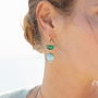 Model wearing MURRINAMURANO Venezia earrings  from the Ocean Odyssey Collection, handcrafted in Original Murano glass, 18KT Gold Finish  over Brass. Made in Italy – murrinamurano.us