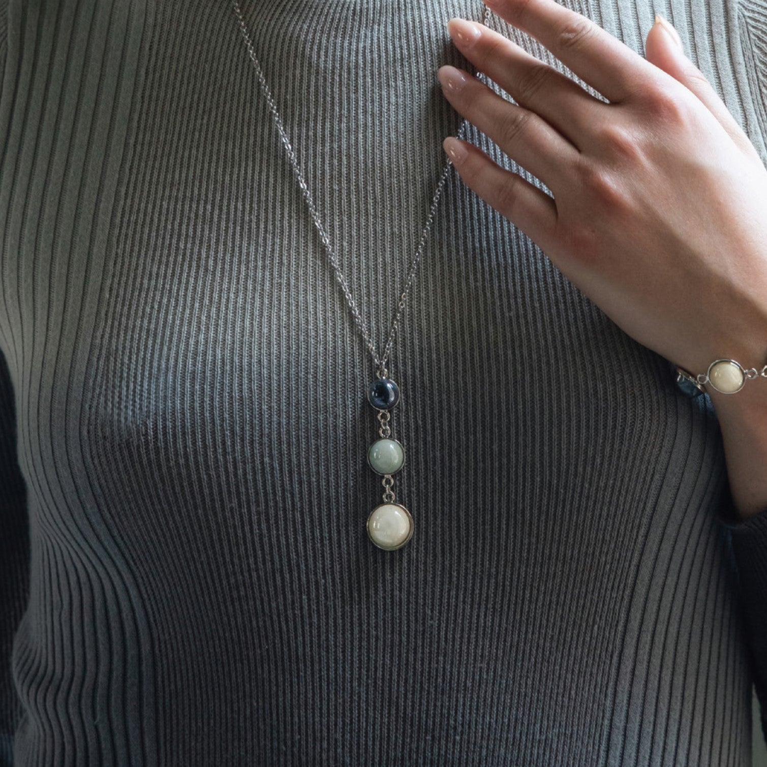 Model wearing MURRINAMURANO Venezia necklace from the Audrey Collection, handcrafted in Original Murano glass, 18KT Gold Finish or Rhodium finish, over Brass. Made in Italy – murrinamurano.us