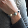 Model wearing MURRINAMURANO Venezia bracelet from the Audrey Collection, handcrafted in Original Murano glass, Rhodium finish over Brass. Made in Italy – murrinamurano.us