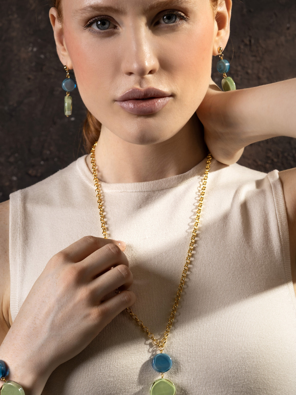 MurrinaMurano.us Edge Murano glass drop earrings with blue and green glass elements, worn with a matching necklace, 18KT Gold Finish over brass, handcrafted in Italy.
