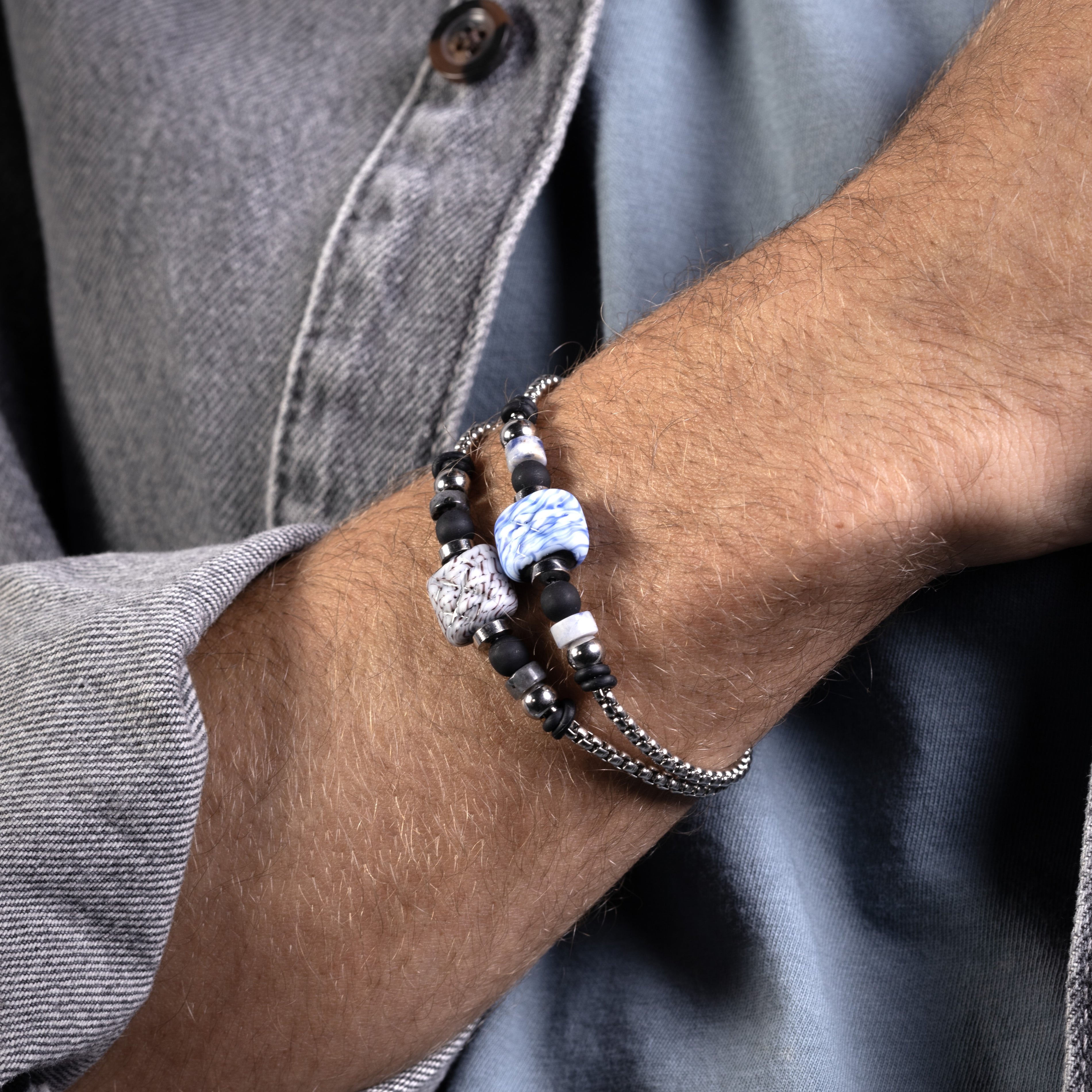 Weld Collection - Murano Glass - Close-up of a wrist wearing a beaded bracelet with a gray shirt background
