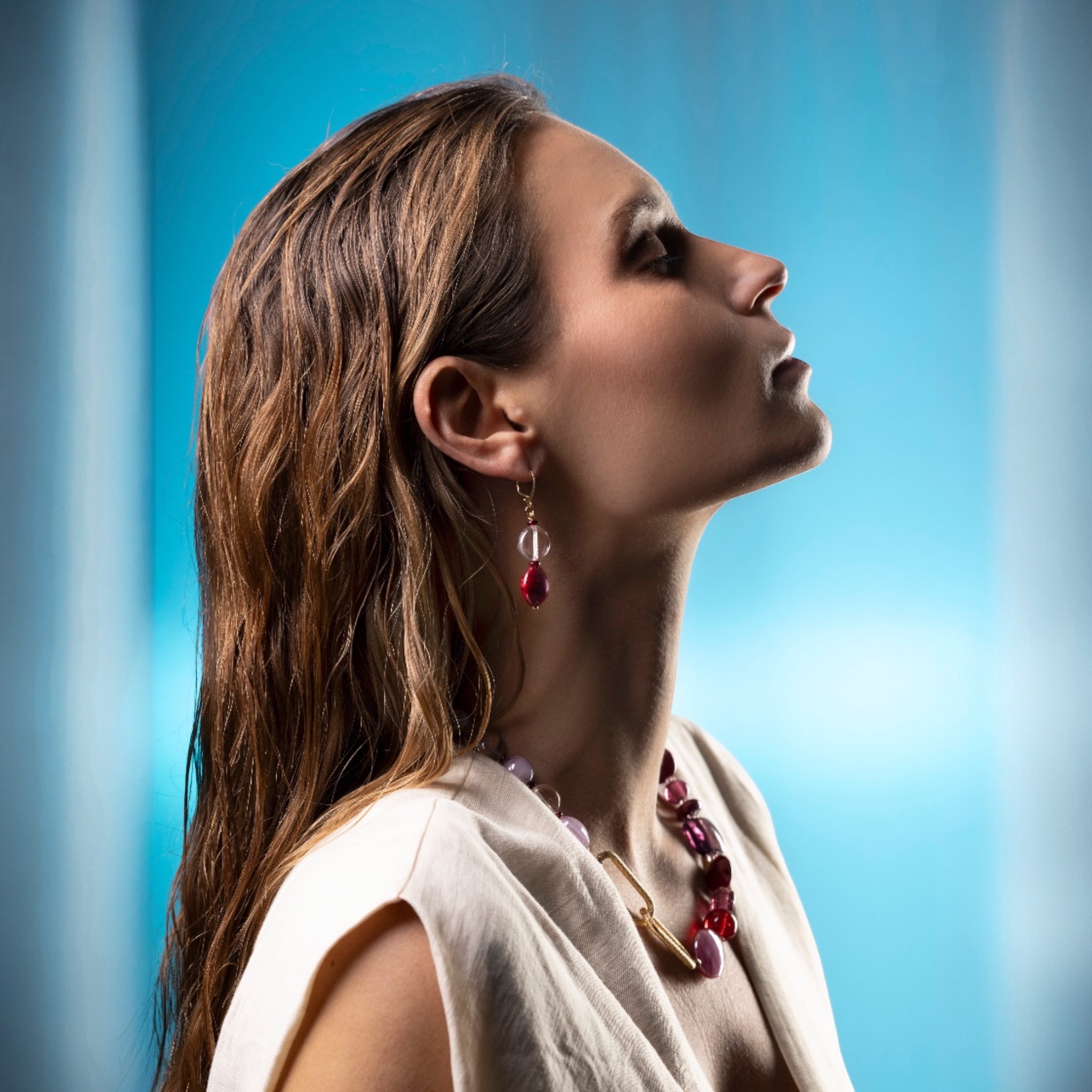 MurrinaMurano.us Breeze Collection necklace with asymmetrical Murano glass beads in red and purple, gold clasp. Matching dangle earrings.