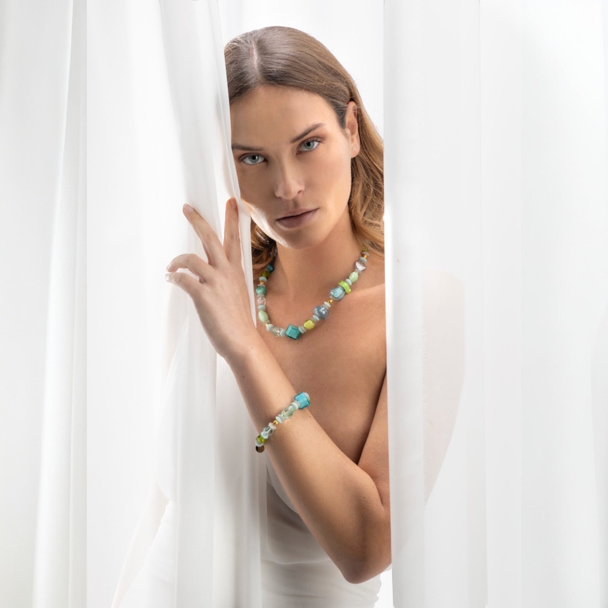 MurrinaMurano.us Evoque bracelet with mixed aqua, green, and yellow Murano glass beads and gold-finished brass accents.