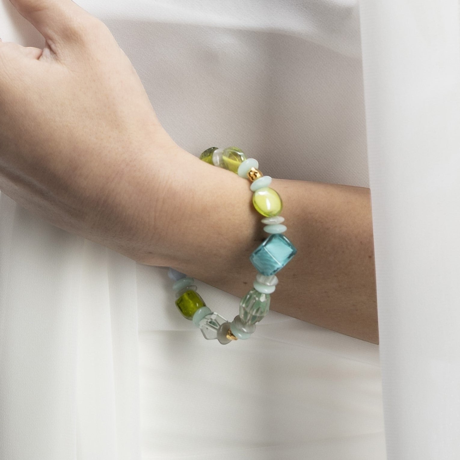 MurrinaMurano.us Evoque bracelet with green and blue Murano glass beads, gold-plated brass, and stainless steel.