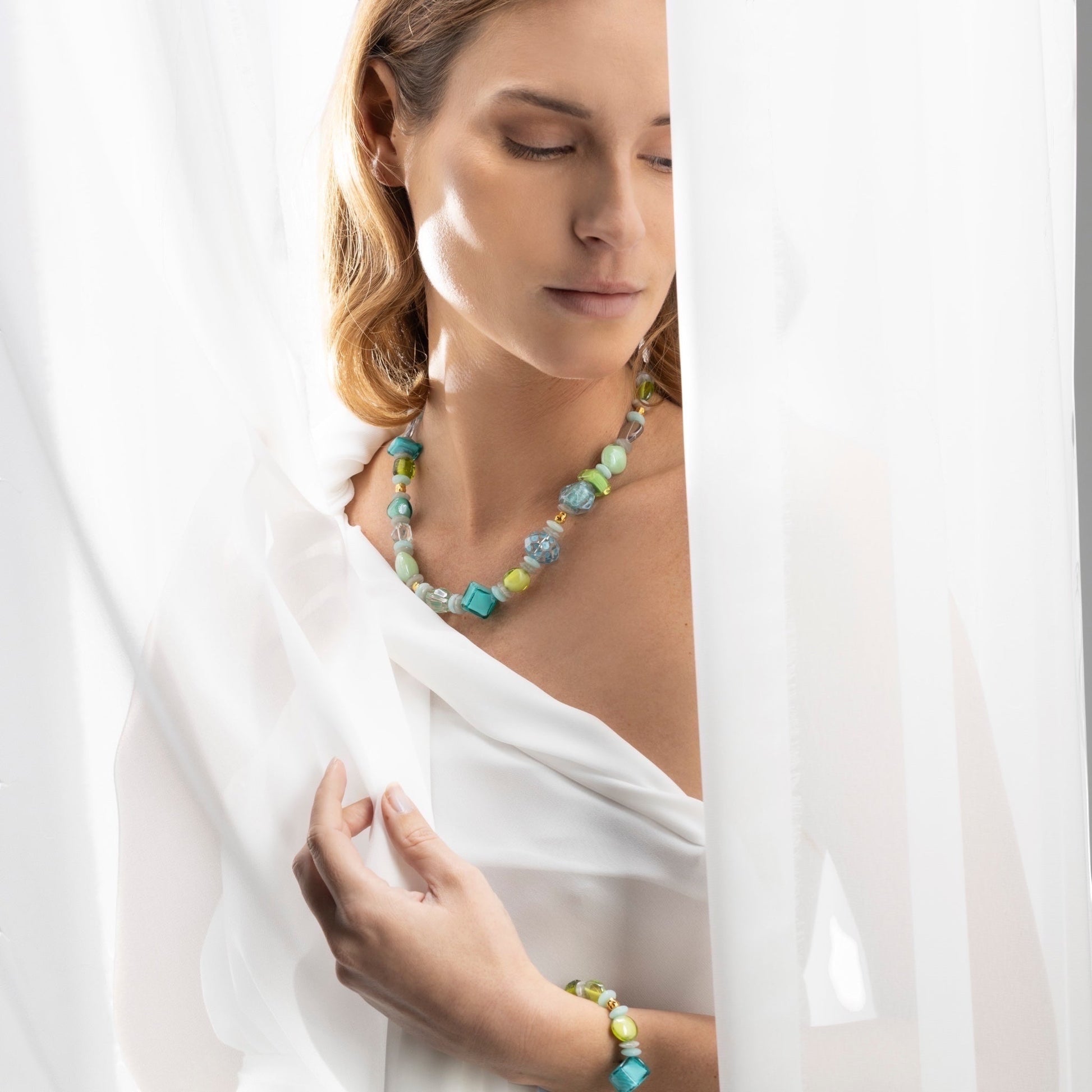 MurrinaMurano.us Evoque Choker necklace with turquoise, green, and clear Murano glass beads and gold accents. Sculptural design.