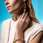 MurrinaMurano.us bracelet with gold oval link and colorful Murano glass beads in green and purple hues.