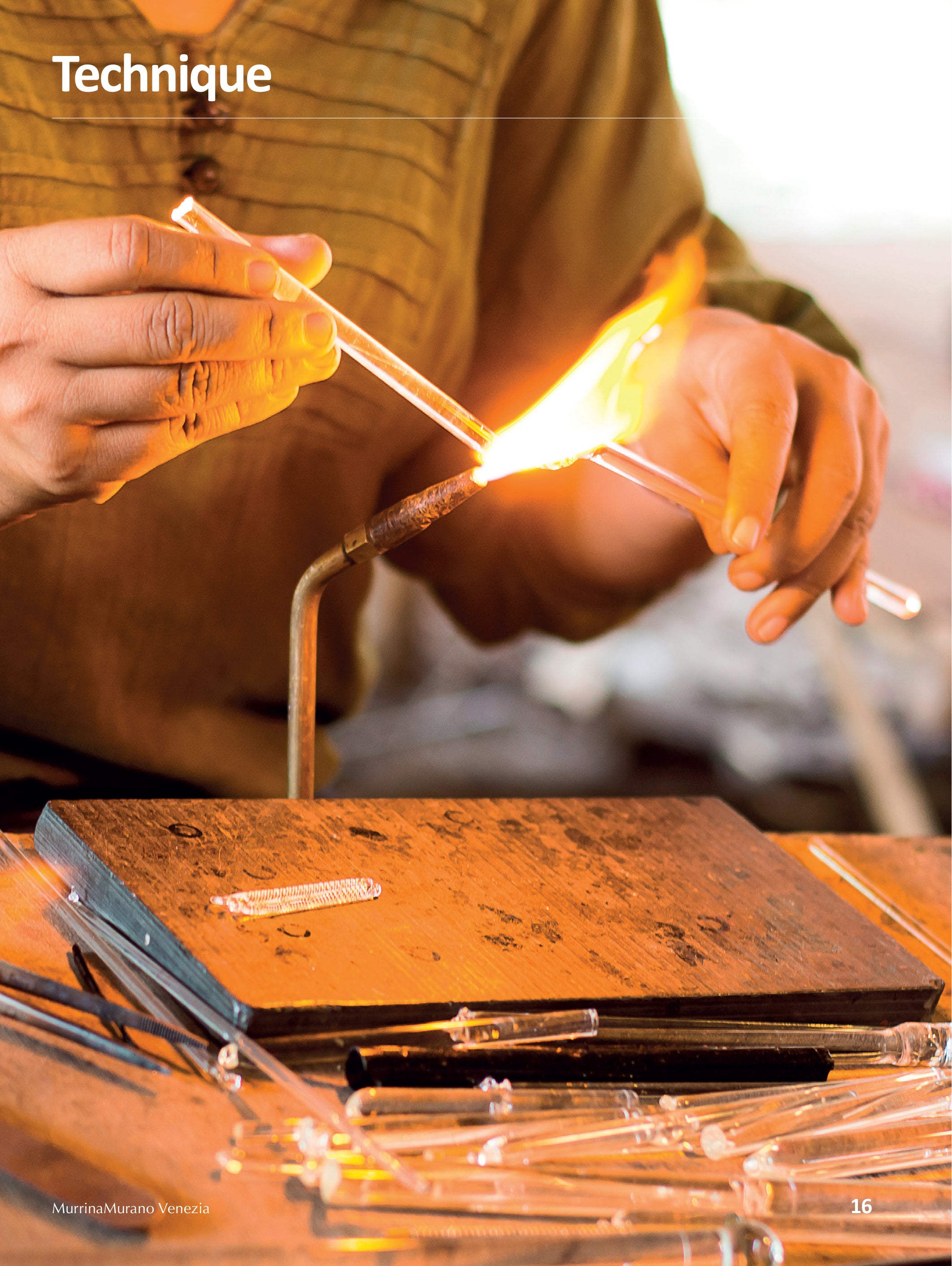 Person working with molten glass using a blowtorch Lampwork Technique